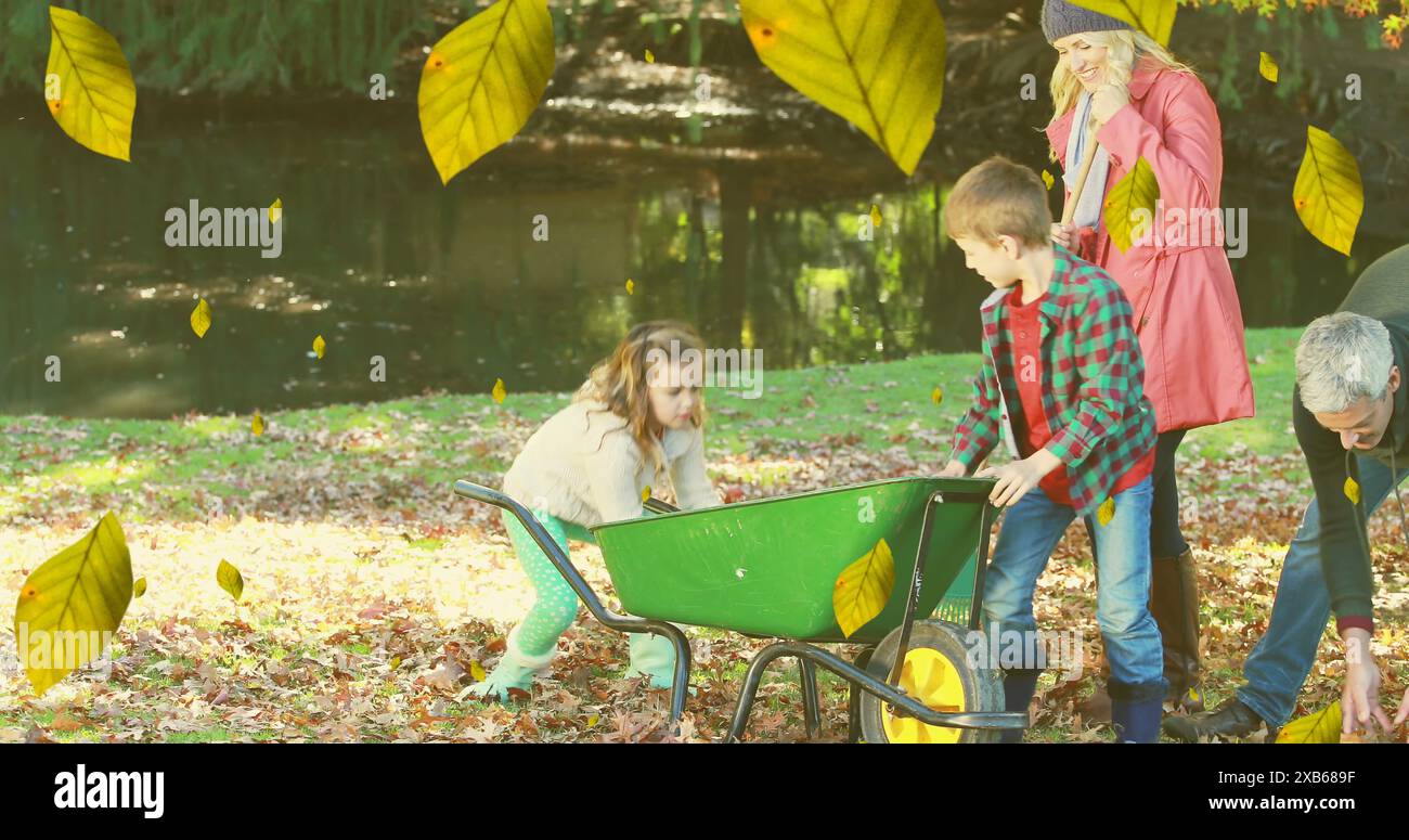 Famille caucasienne profitant de l'automne en plein air, les enfants jouant avec la brouette Banque D'Images