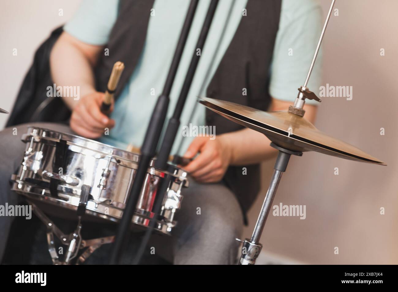 Drummer joue du tambour et des cymbales, photo en gros plan avec flou sélectif. Photo de fond de musique live Banque D'Images