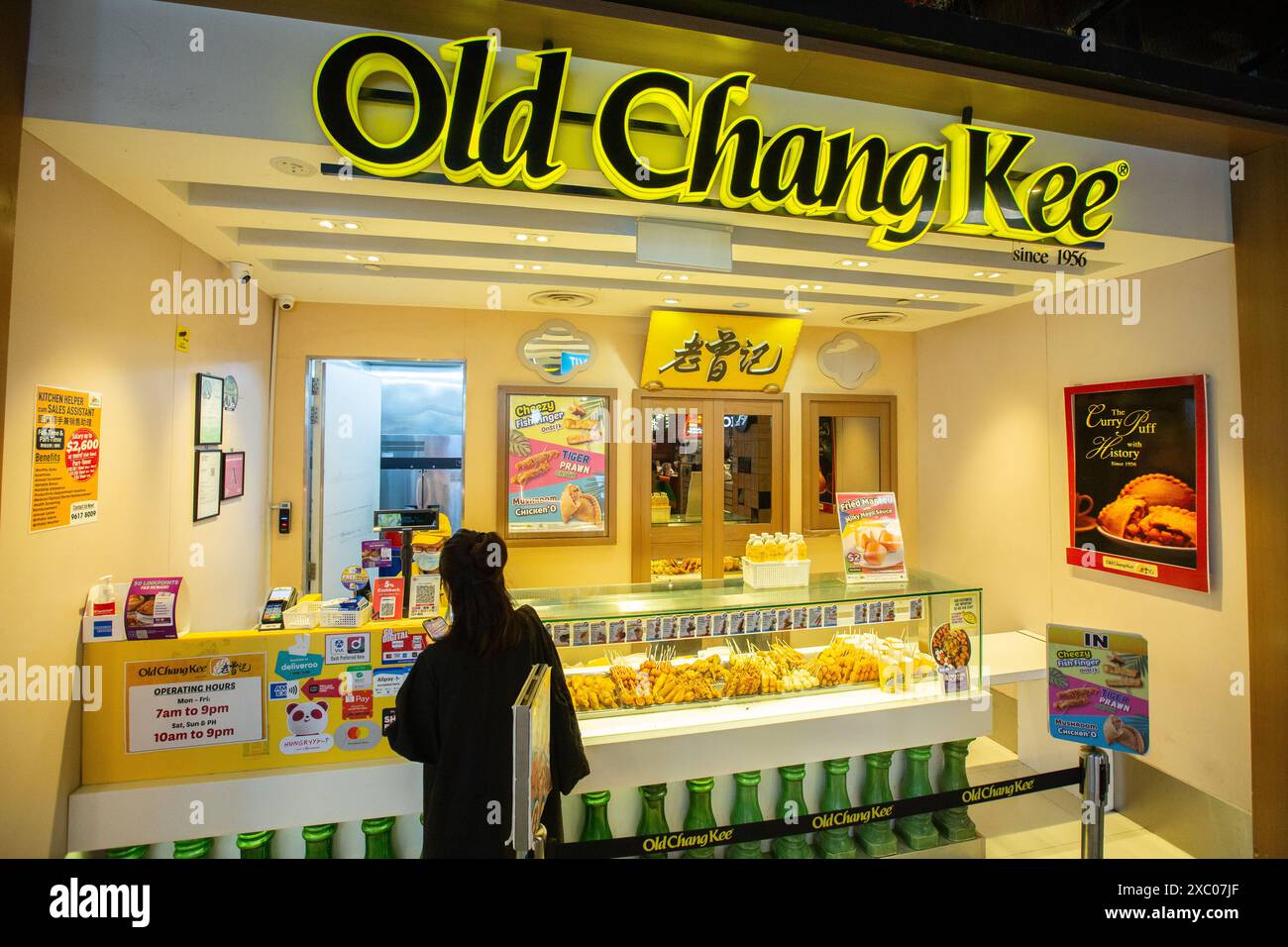 Une femme qui effectue un paiement dans les kiosques de sortie de l'établissement Old Chang Kee, les collations sont à emporter. Singapour. Banque D'Images