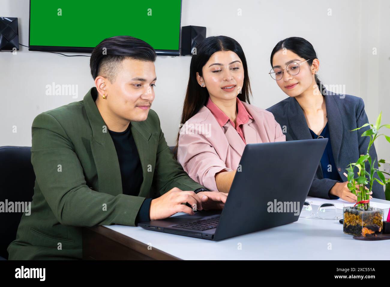 une équipe de bureau d'homme et de femme d'affaires devant un écran vert dans une table de réunion discutant Banque D'Images