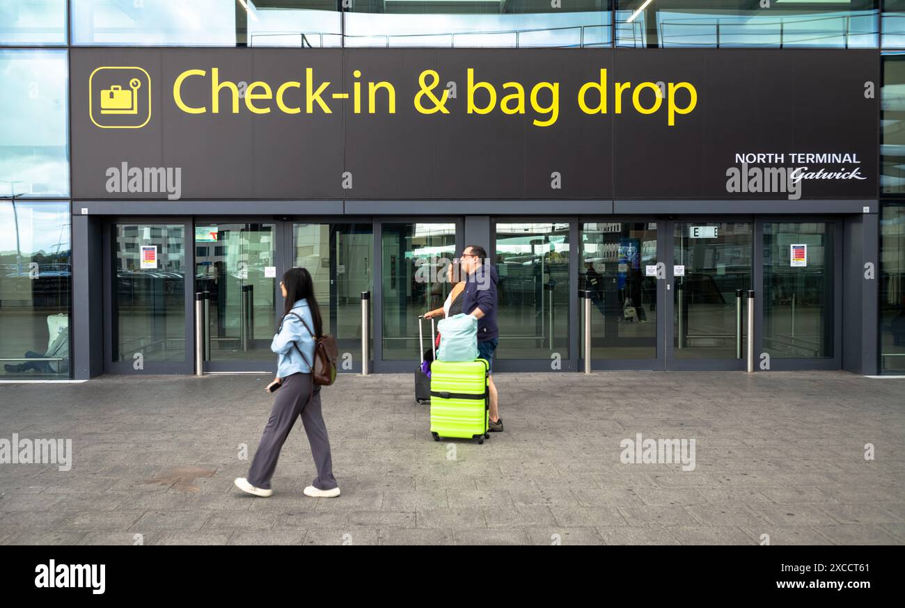 Un grand panneau indiquant « check-in & bag drop » au-dessus d'une entrée pour l'enregistrement et les départs au terminal nord, aéroport de Londres Gatwick, West Sussex, Royaume-Uni Banque D'Images