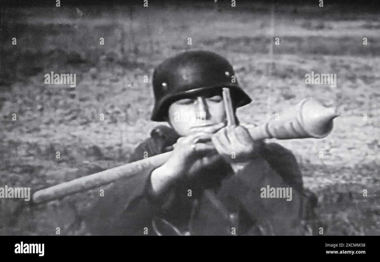 Photo de capture d'écran de la seconde Guerre mondiale B&W . Un soldat allemand vise une arme anti-char Panzerfaust depuis la tranchée à un Grouns d'entraînement en Allemagne 1944 Banque D'Images