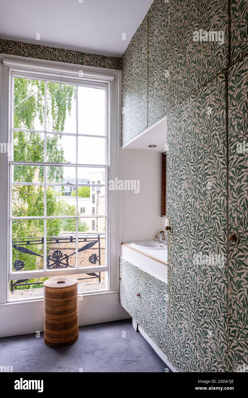 Salle de bains tapissée de William Morris 'Willow Bogs'. Terrasse victorienne classée grade II, Camden, Londres, Royaume-Uni Banque D'Images