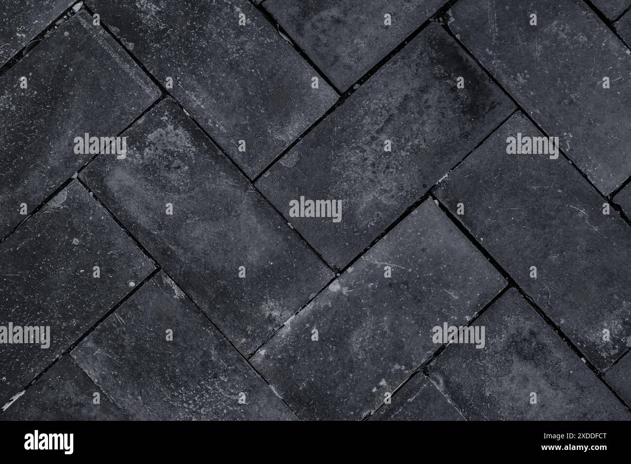 Pavage en zigzag blocs pierres motif carreaux de rue trottoir. Pierres de pavage. Pavé de rue, sentier de tuile de surface du sol, parc trottoir, route ou Banque D'Images