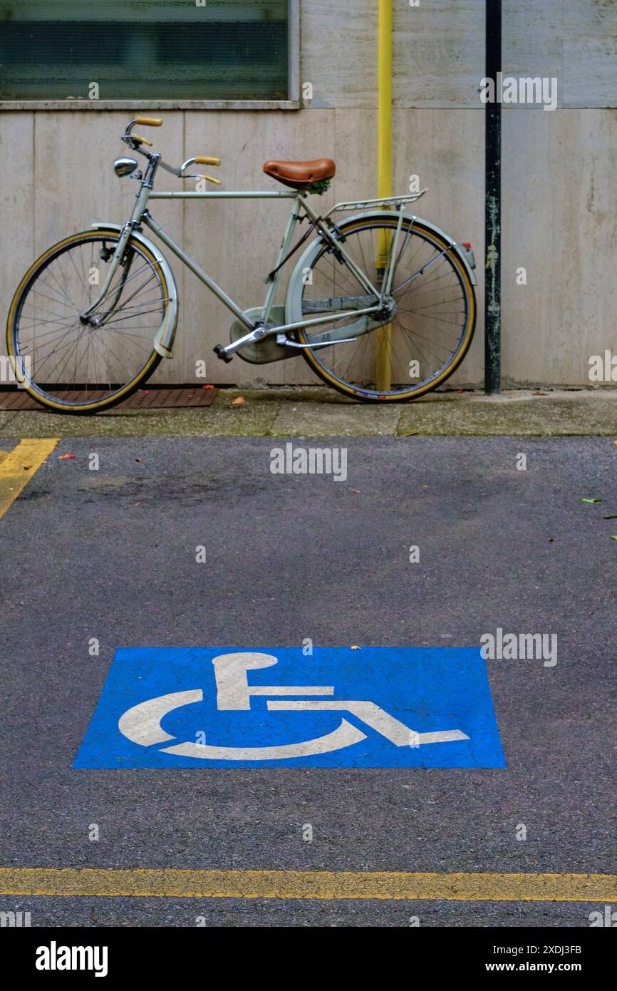 Cremona, Italie - 21 juin 2024 Vintage vélo est garé dans un espace de stationnement réservé aux personnes handicapées, soulignant les questions d'accessibilité et de re Banque D'Images