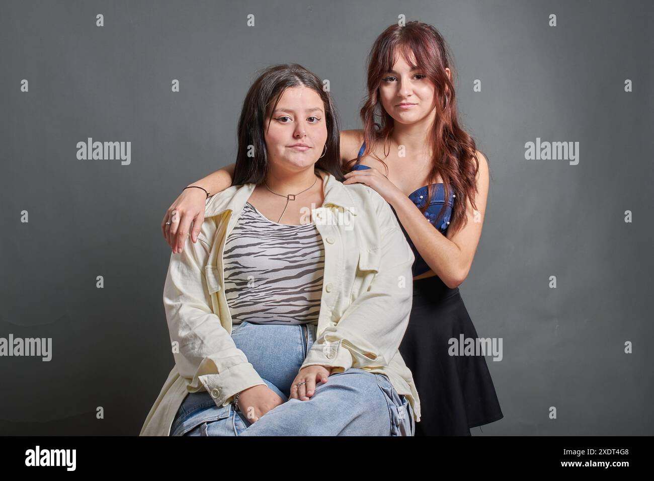Deux amis hispaniques posant devant la caméra, une relation d'amitié et d'inclusion. Photographie de mode d'adolescents regardant l'appareil photo Banque D'Images