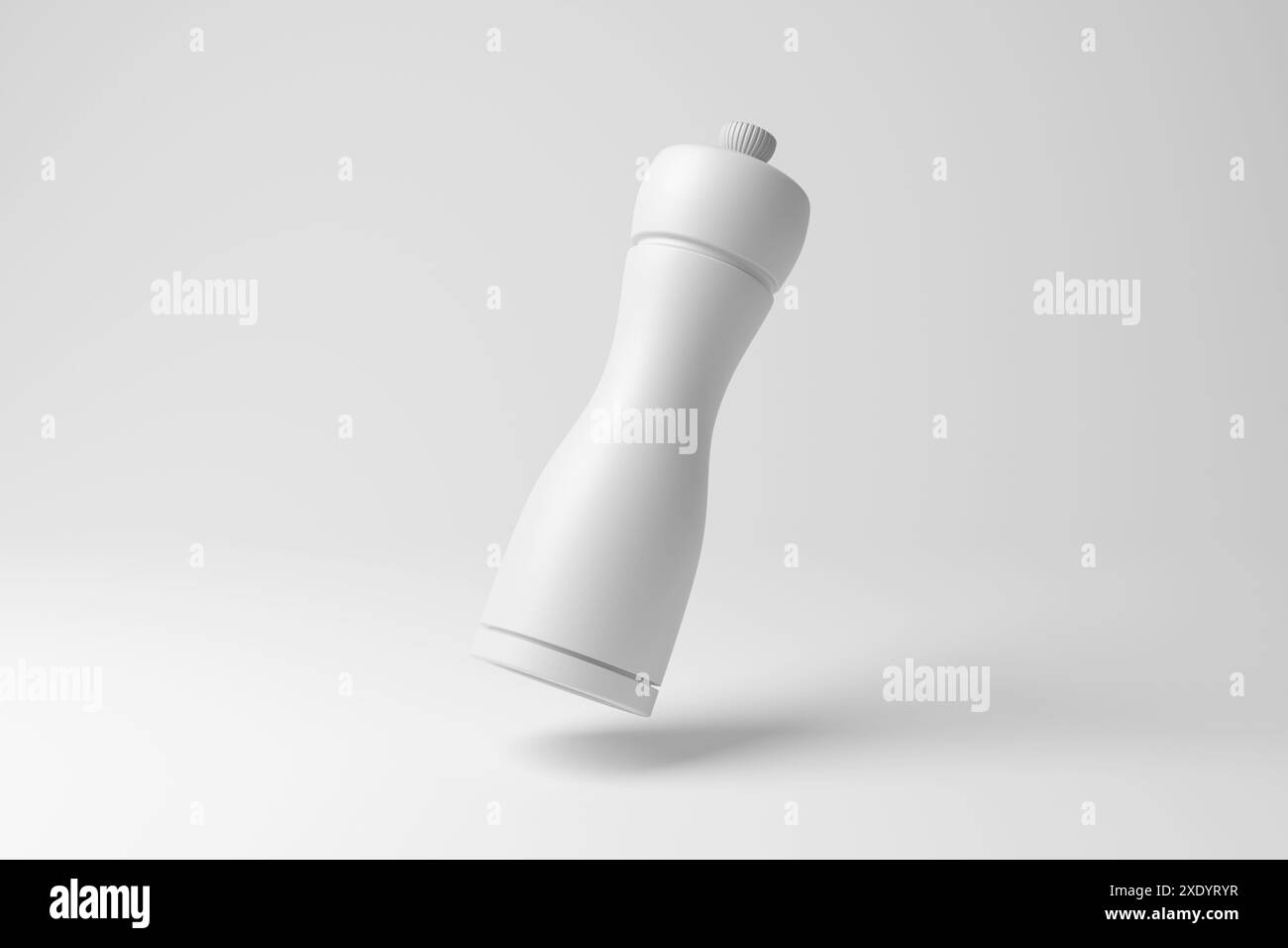 Moulin à épices blanc flottant dans les airs sur fond blanc en monochrome et minimalisme. Concept de condiments, d'assaisonnement alimentaire et de cuisson Banque D'Images