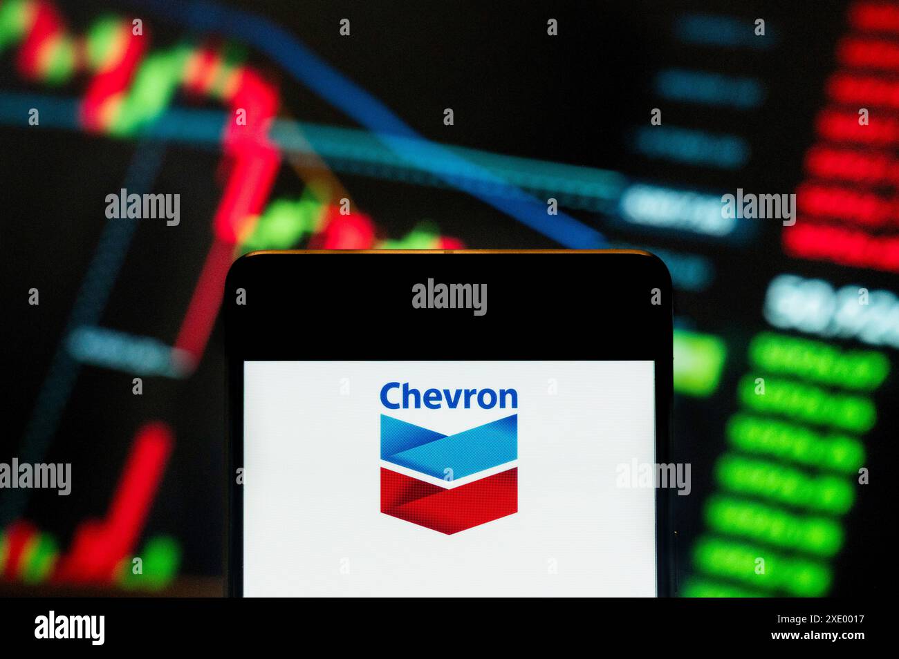 Chine. 21 juin 2024. Dans cette illustration photo, le logo de la multinationale américaine Chevron Corporation (NYSE : CVX) est affiché sur un smartphone avec un graphique de l'indice boursier économique en arrière-plan. Crédit : SOPA images Limited/Alamy Live News Banque D'Images