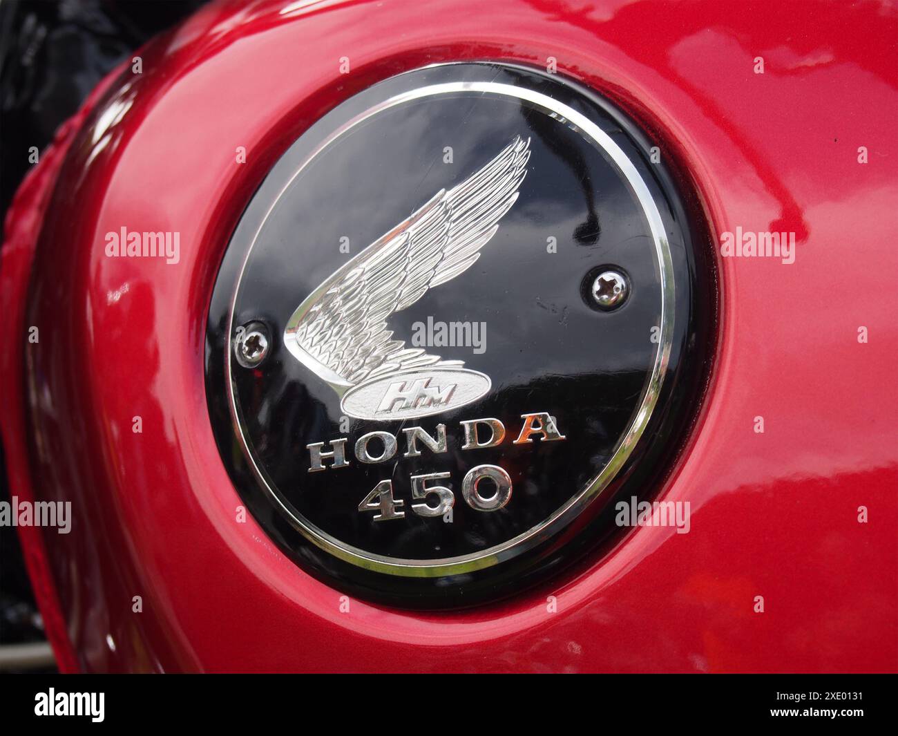 Gros plan d'un logo honda noir et chromé sur le réservoir d'une moto rouge vintage 450 Banque D'Images Gros plan d'un logo honda noir et chromé sur le réservoir d'une moto rouge vintage 450 Banque D'Images