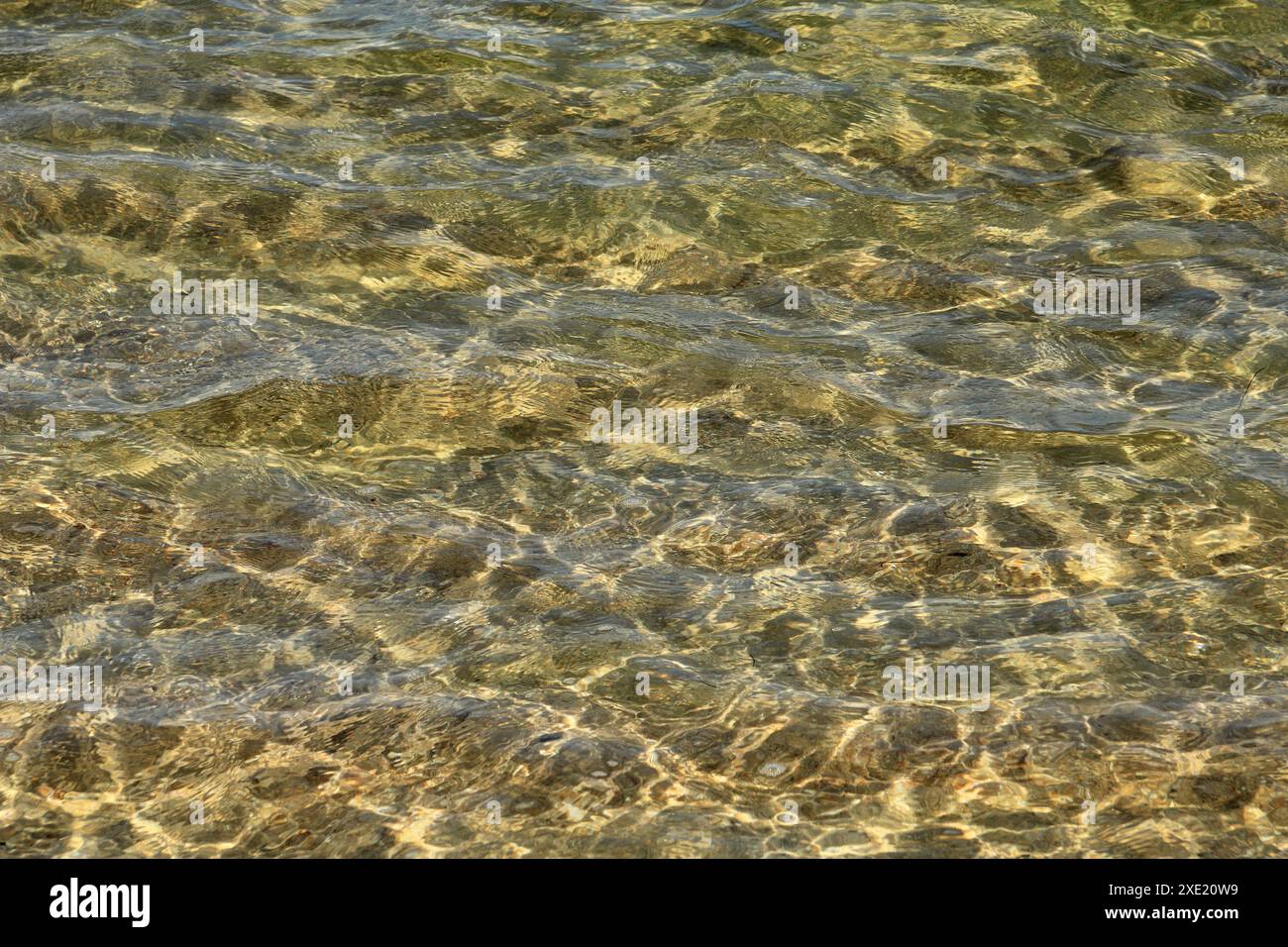 Concept. vacances d'été. Eau de mer scintillante limpide et limpide se lavant sur une plage de sable doré. Algarve, Portugal. Banque D'Images