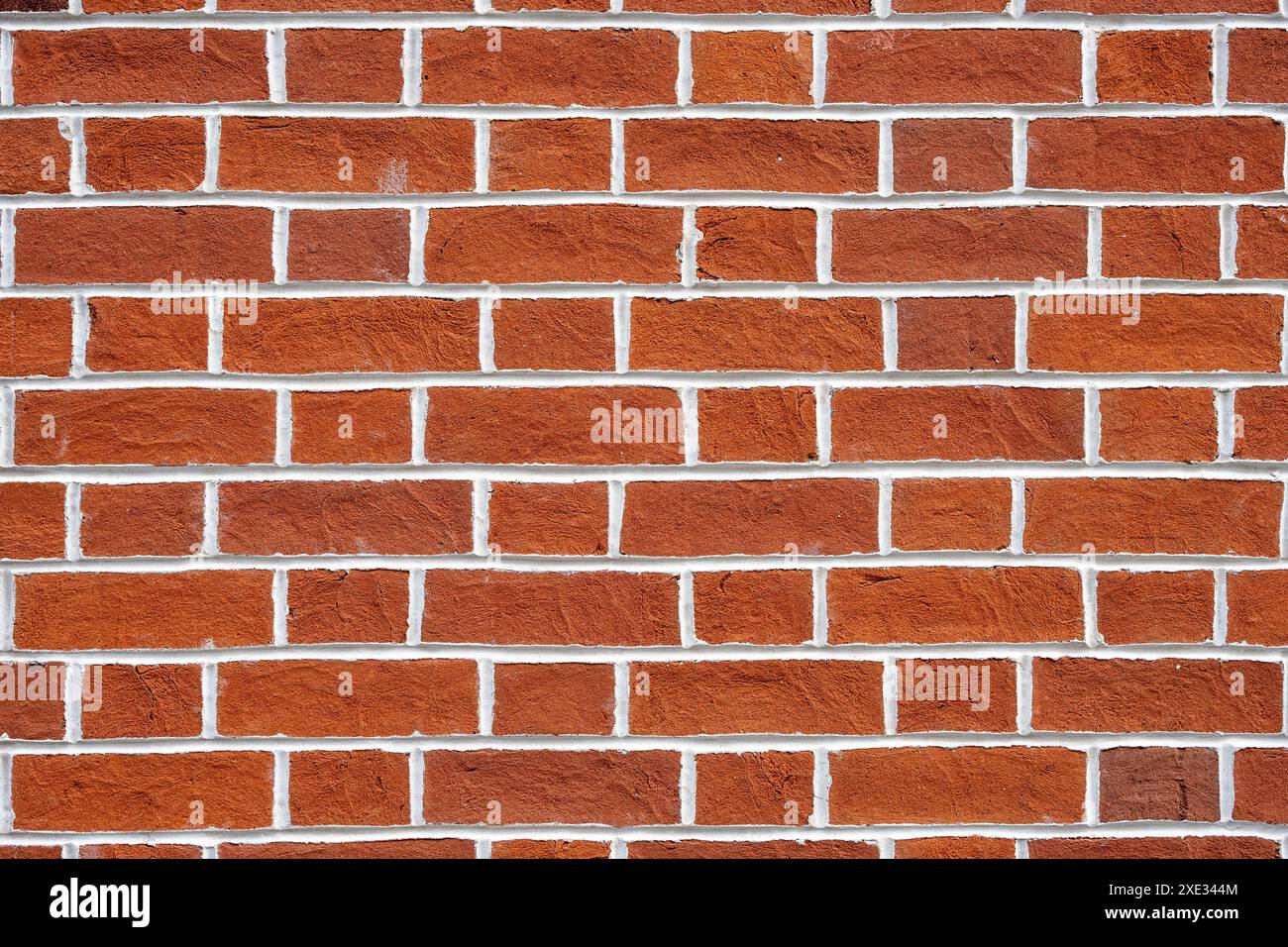 Fond d'un mur de briques rouges avec des joints blancs Banque D'Images