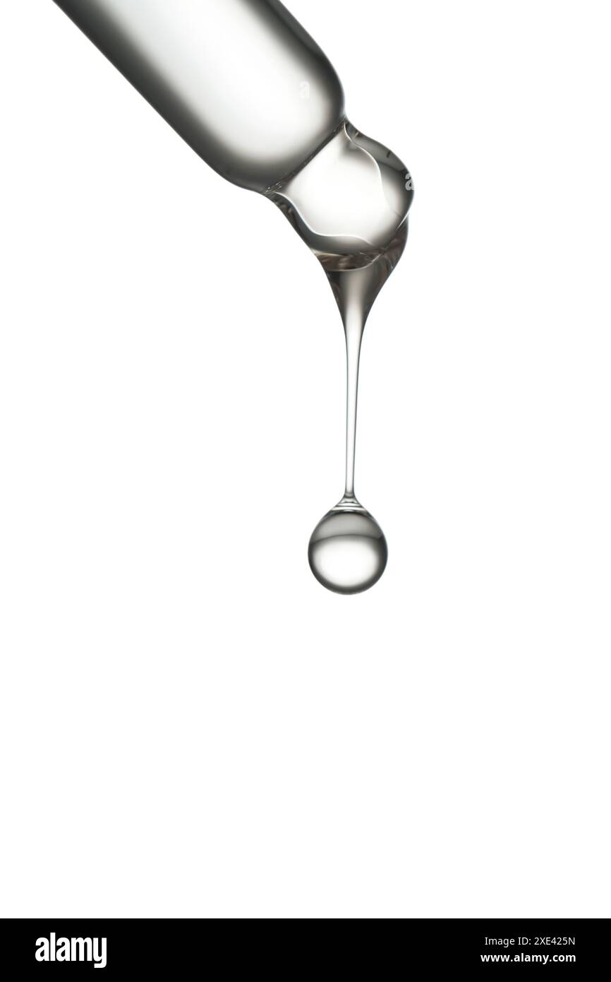 Pipette transparente avec sérum sur fond blanc isolé. Banque D'Images