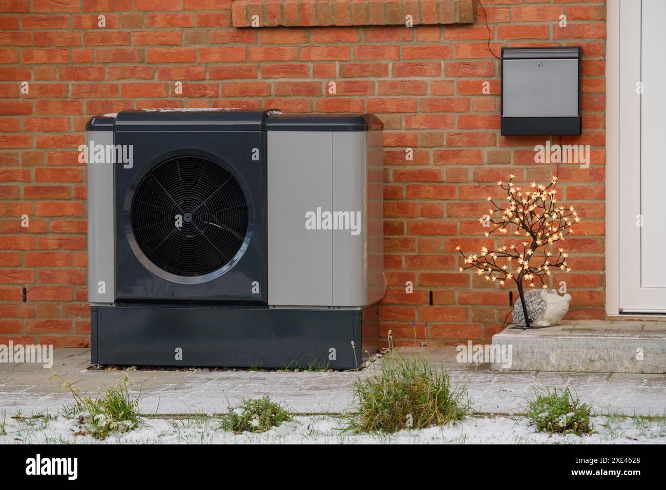 Pompe à chaleur à air installée sur la façade extérieure du résidentiel multifamilial avec lumière de noël. Banque D'Images