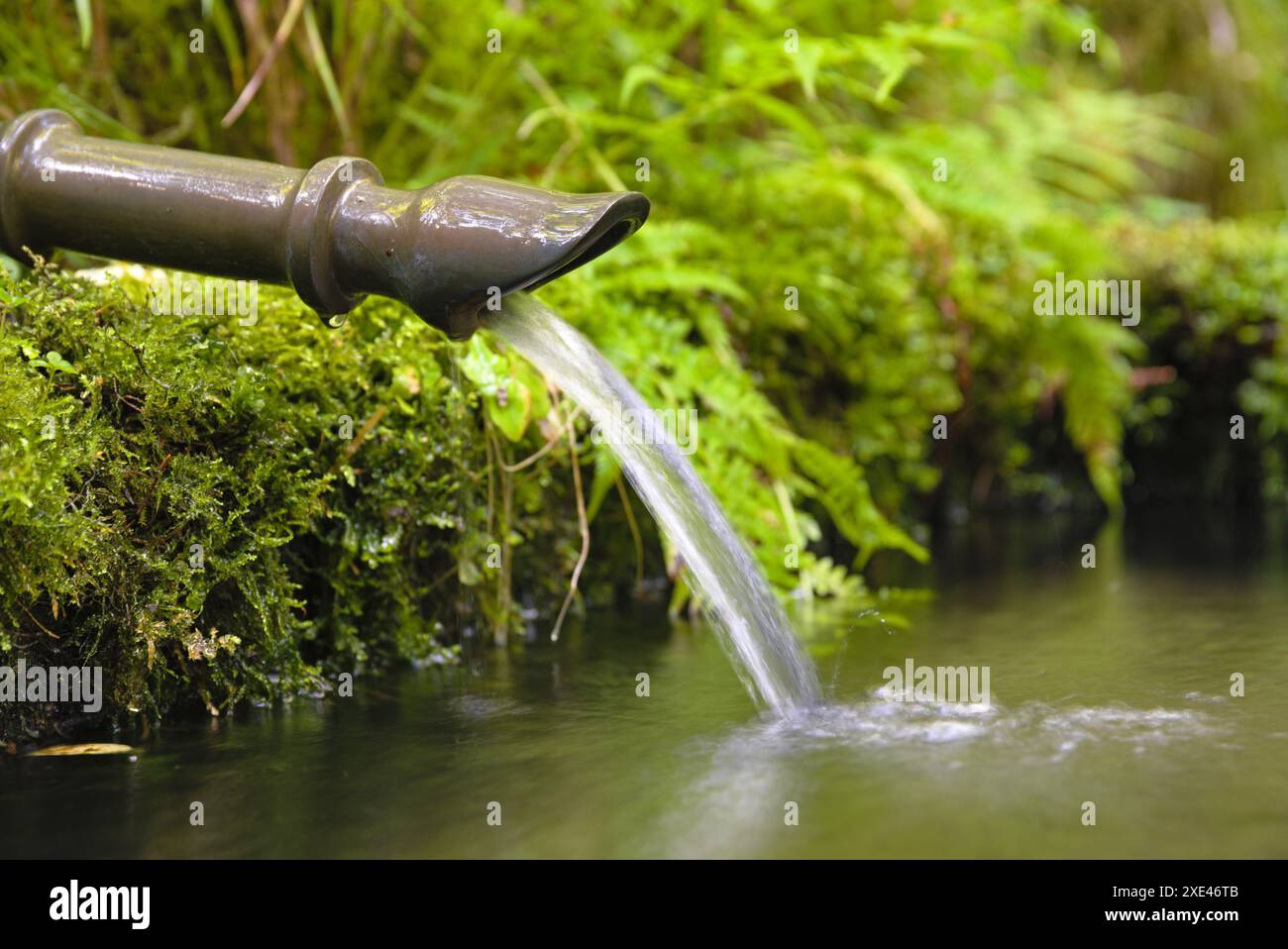 Rafraîchir l'eau courante de la conduite d'eau dans les fontaines ornementales couvertes de mousse Banque D'Images