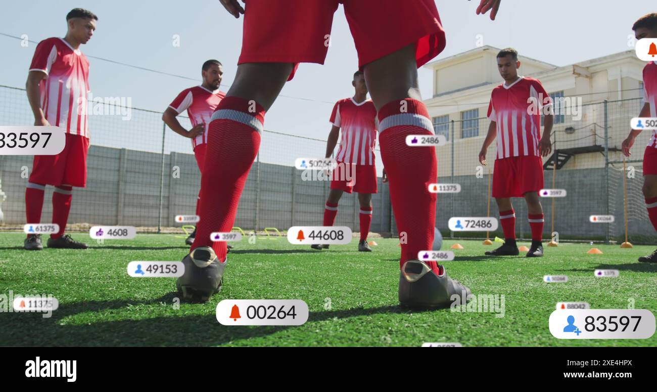 Image de plusieurs barres de notification au-dessus de divers joueurs de football effectuant des exercices de dépassement au sol Banque D'Images