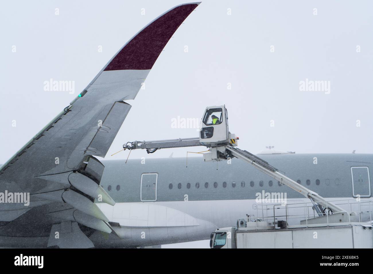 Dégivrage de l'avion avant le vol. La machine de dégivrage saupoudre l'aile d'un avion de passagers d'antigel. Hiver à l'aéroport. Neige. Manutention aérienne. Vapeur dans le froid. Service aéroport Banque D'Images