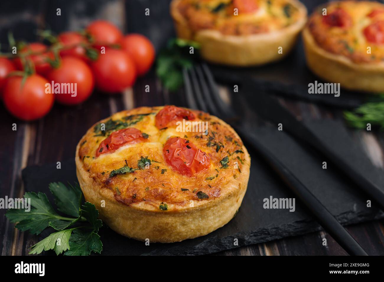 Tartes au cheddar et à l'omelette à l'oignon de printemps servies sur une planche de bois Banque D'Images