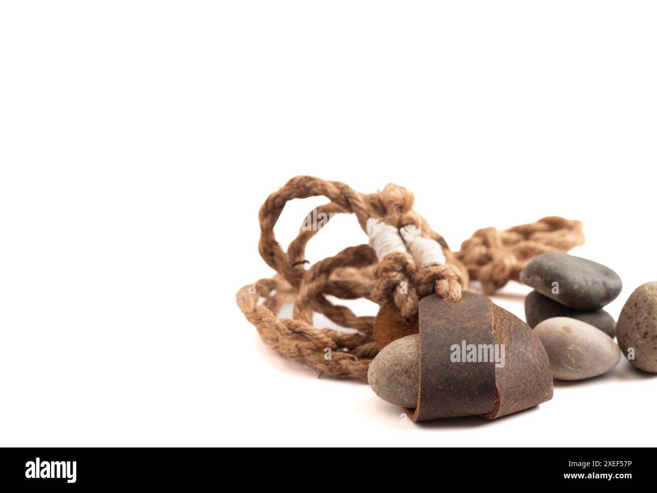 Sling Shot and Stones on a White background de l'histoire de David et Goliath dans la Bible Banque D'Images