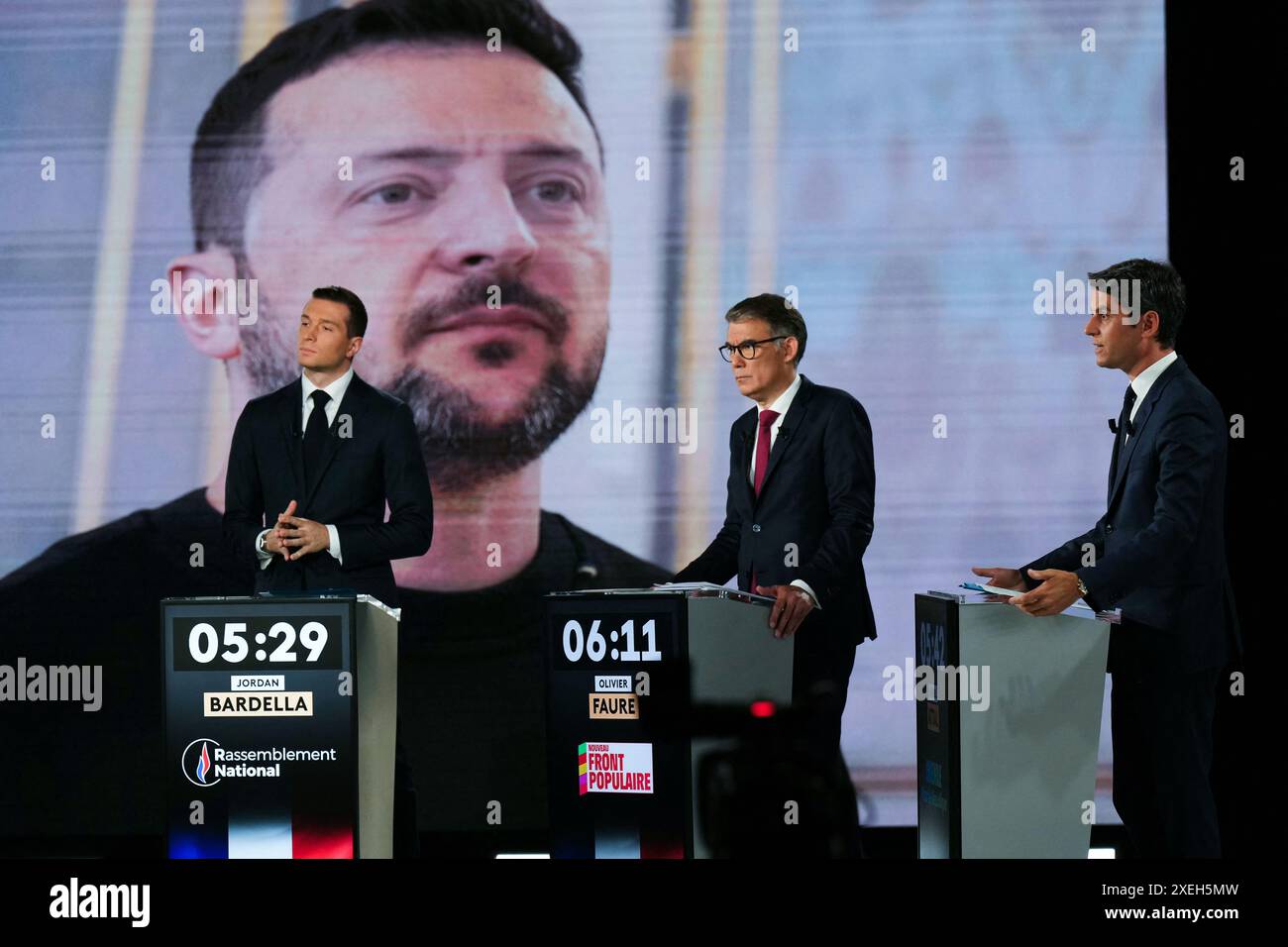Premier secrétaire du Parti socialiste de gauche (PS) et député Olivier Faure (C), Jordan Bardella (G), président du parti d’extrême droite rassemblement National (RN) et eurodéputé principal français, et Gabriel Attal, premier ministre français, se tiennent devant un écran montrant une photo du président ukrainien Volodymyr Zelensky alors qu’ils participent à un débat politique diffusé sur la chaîne de télévision française France 2 à Paris le 27 juin 2024, à la veille des élections anticipées en France pour une nouvelle Assemblée nationale. Photo Dimitar Dilkoff/Pool/ABACAPRESS. COM Banque D'Images