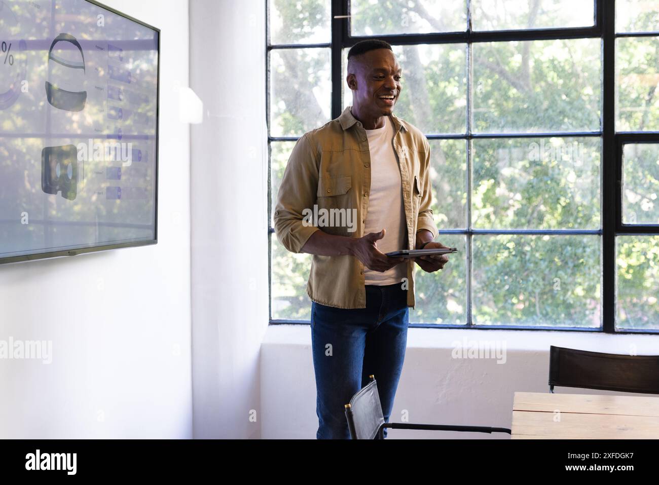 Présentation d'idées d'affaires, homme tenant la tablette et debout dans le bureau moderne, espace de copie Banque D'Images