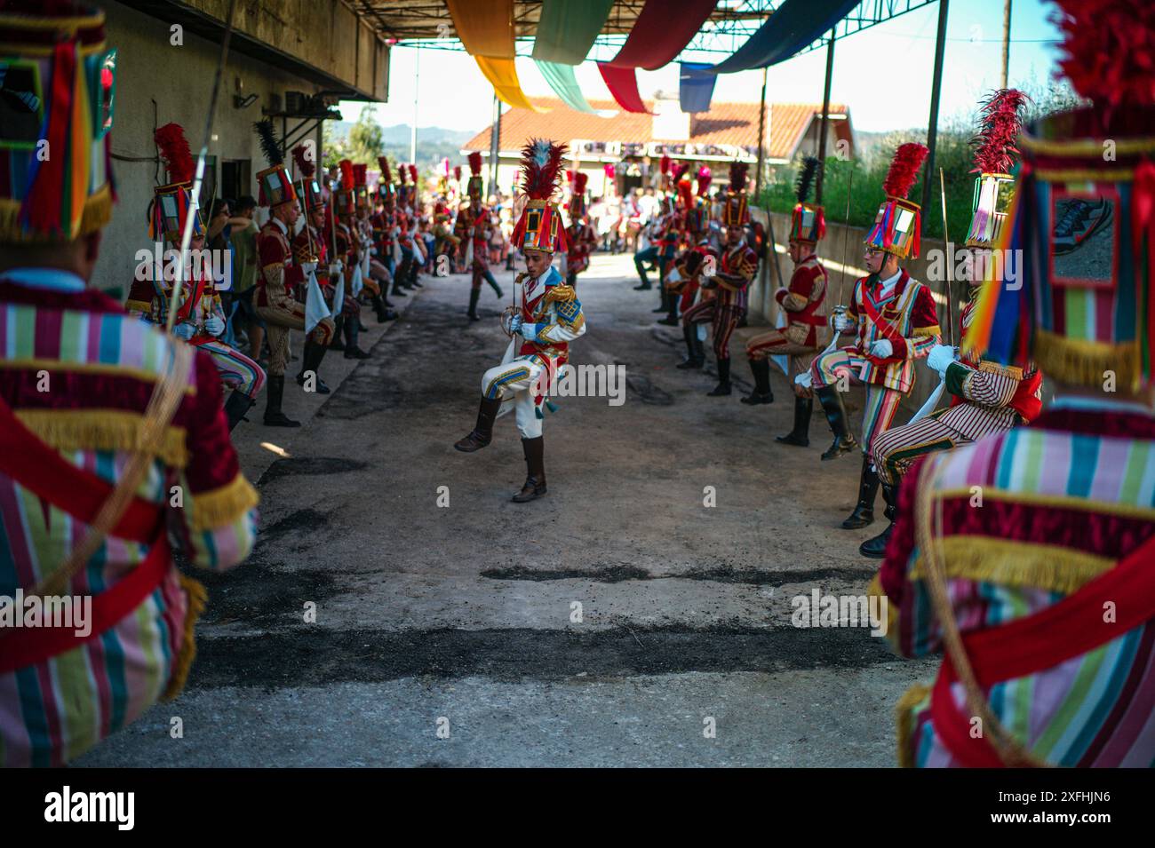Le festival 'Bugiada e Mouriscada' à São João de Sobrado, Valongo, Portugal, prend vie le 24 juin avec les Mourisqueiros portant des costumes colorés, reconstituant des batailles historiques contre les Bugios dans une célébration vibrante de la tradition et de l'histoire. Banque D'Images