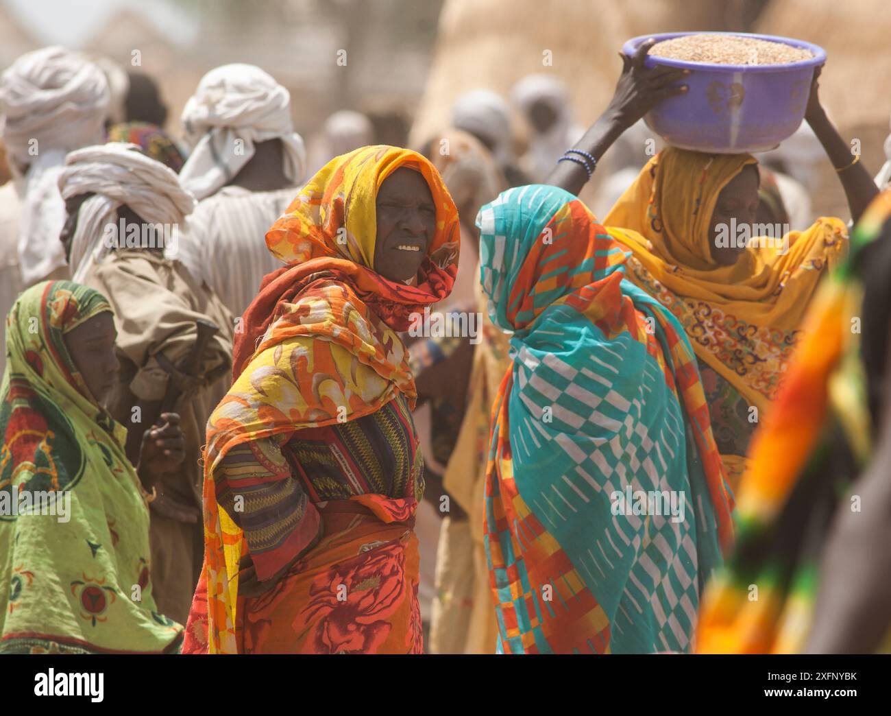 Femmes de la tribu Ouled Rachid au marché, dont une portant un bol de grain sur la tête, village de Kashkasha près du parc national de Zakouma, Tchad, 2010. Banque D'Images