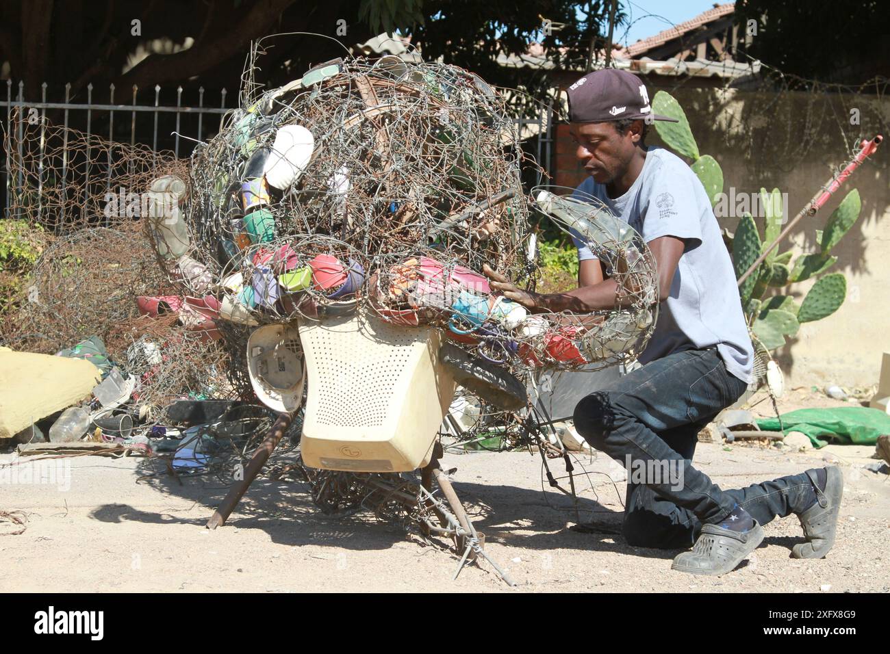 Chitungwiza, province de Harare. 3 juillet 2024. Johnson Zuze, artiste zimbabwéen de techniques mixtes, réalise une sculpture avec du fil de fer et d'autres objets trouvés dans un atelier à Chitungwiza, dans la province de Harare, au Zimbabwe, le 3 juillet 2024. POUR ALLER AVEC 'Feature : un artiste zimbabwéen transforme les outils des braconniers en un puissant art de la conservation' crédit : Tafara Mugwara/Xinhua/Alamy Live News Banque D'Images