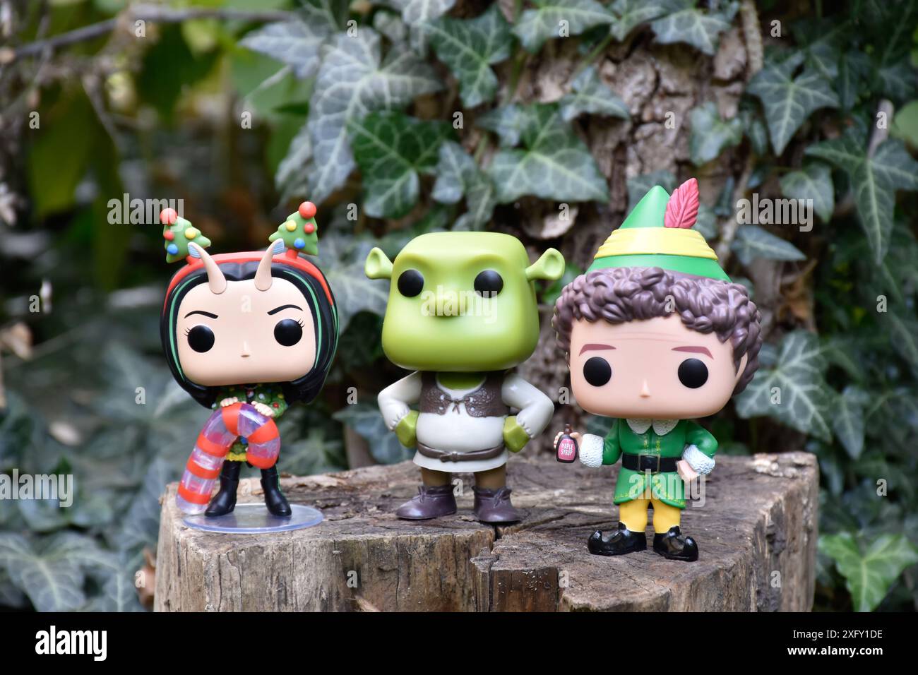 Funko figurines pop de Buddy Elf, ogre Shrek et Mantis des Gardiens de la Galaxie. Feuilles de lierre vertes, bois, lieu de fée. Banque D'Images