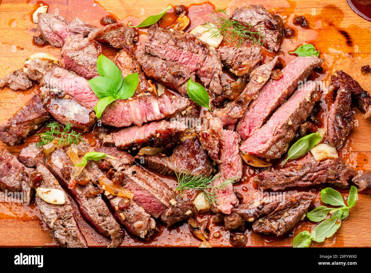 Steak juteux d'oeil de côte moyen tranché sur une planche de bois. Vue de dessus. Banque D'Images