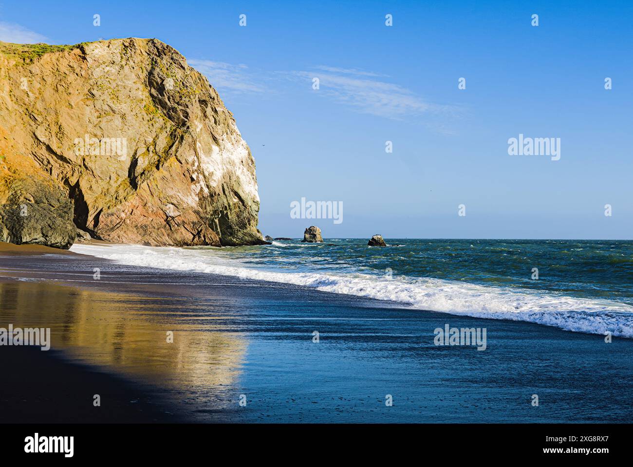 Plage californienne avec falaises, vagues et reflets. Banque D'Images