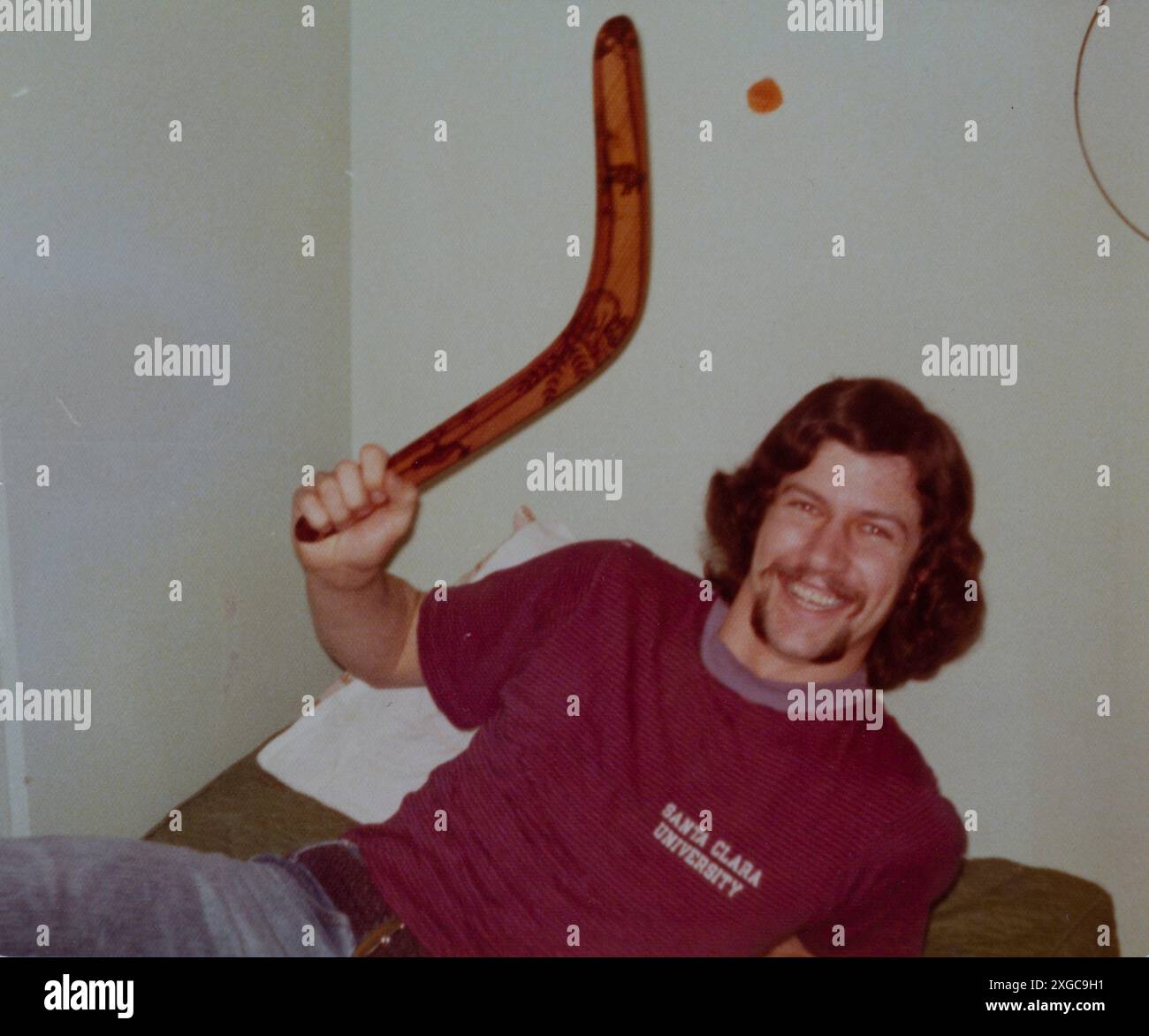 Uni étudiant tenant un Boomerang dans son dortoir sur le campus, Université Santa Clara, CA, 1974 Banque D'Images