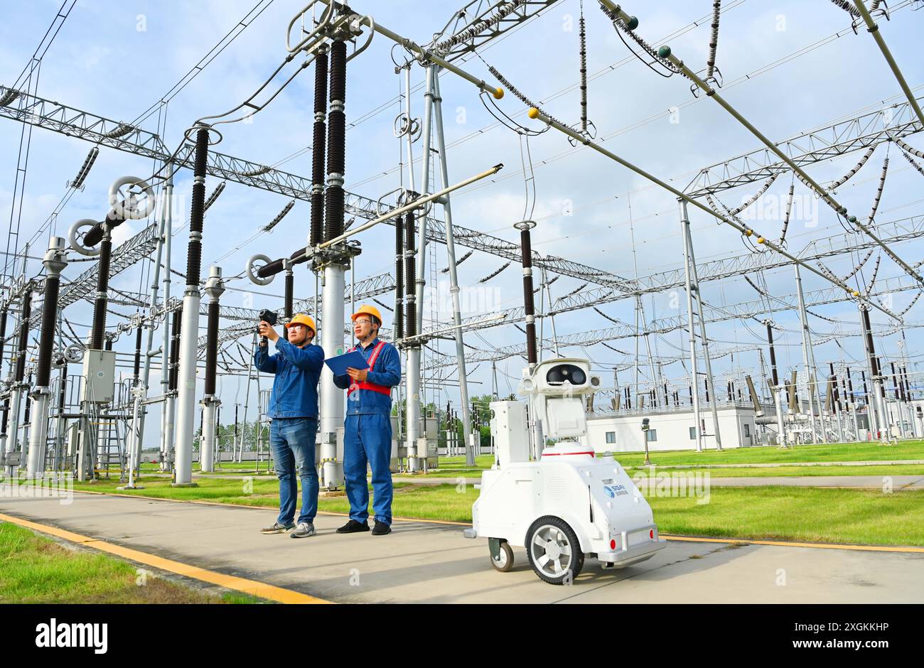 CHUZHOU, CHINE - 9 JUILLET 2024 - Un robot intelligent 5G et le personnel d'exploitation et de maintenance effectuent une inspection spéciale de l'alimentation électrique Equi Banque D'Images