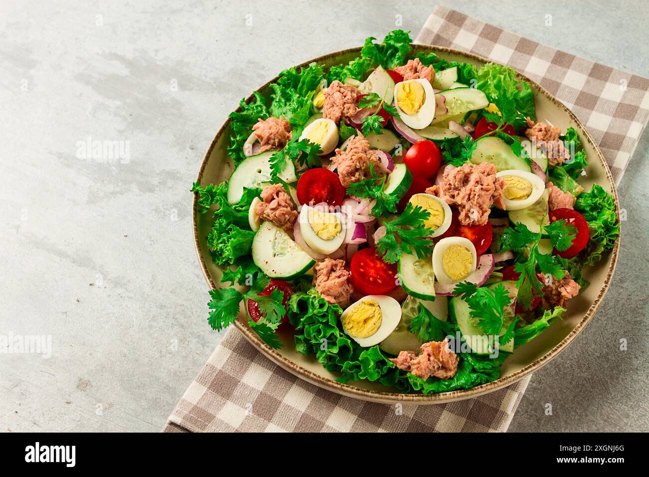 Salade de thon, salade de légumes avec œufs de caille, laitue, oignon rouge et concombres, sur une table gris clair, céto-nourriture, style de vie, alimentation saine, sélective Banque D'Images