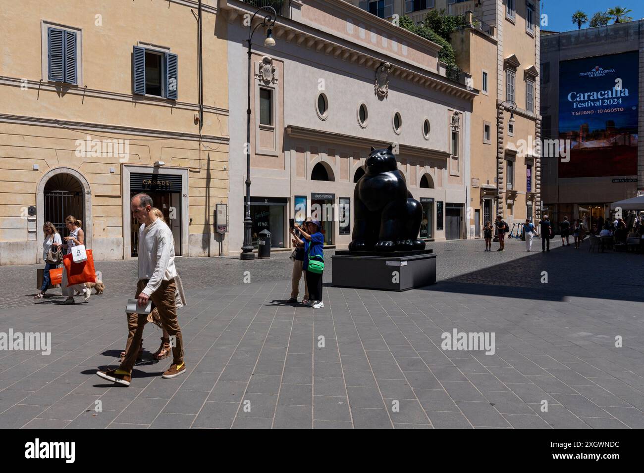 Les touristes prennent une photo devant 'Cat' - qui fait partie de 'Botero a Roma' : un itinéraire d'exposition qui serpente dans les rues du centre-ville de Rome, combinant la beauté des œuvres de Fernando Botero avec la monumentalité de la capitale. La beauté contemporaine des sculptures de Fernando Botero complète le charme extraordinaire et unique de la capitale. L’exposition, qui s’étend sur quelques-unes des plus belles places du centre de Rome, permet de comparer deux mondes. Un hommage de la capitale au grand sculpteur colombien, récemment décédé, qui enrichit certains de ses plus célèbres lo Banque D'Images