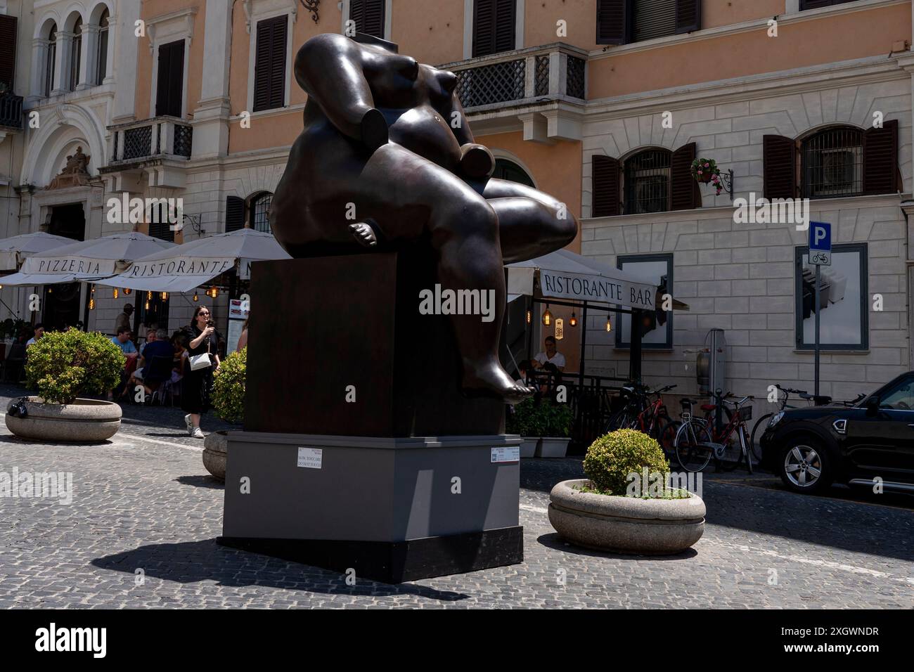 "Sitting Woman" - fait partie de "Botero a Roma" : un itinéraire d'exposition qui serpente dans les rues du centre-ville de Rome, combinant la beauté des œuvres de Fernando Botero avec la monumentalité de la capitale. La beauté contemporaine des sculptures de Fernando Botero complète le charme extraordinaire et unique de la capitale. L’exposition, qui s’étend sur quelques-unes des plus belles places du centre de Rome, permet de comparer deux mondes. Un hommage de la capitale au grand sculpteur colombien, récemment décédé, qui enrichit certains de ses lieux les plus renommés avec 8 sculptures Banque D'Images