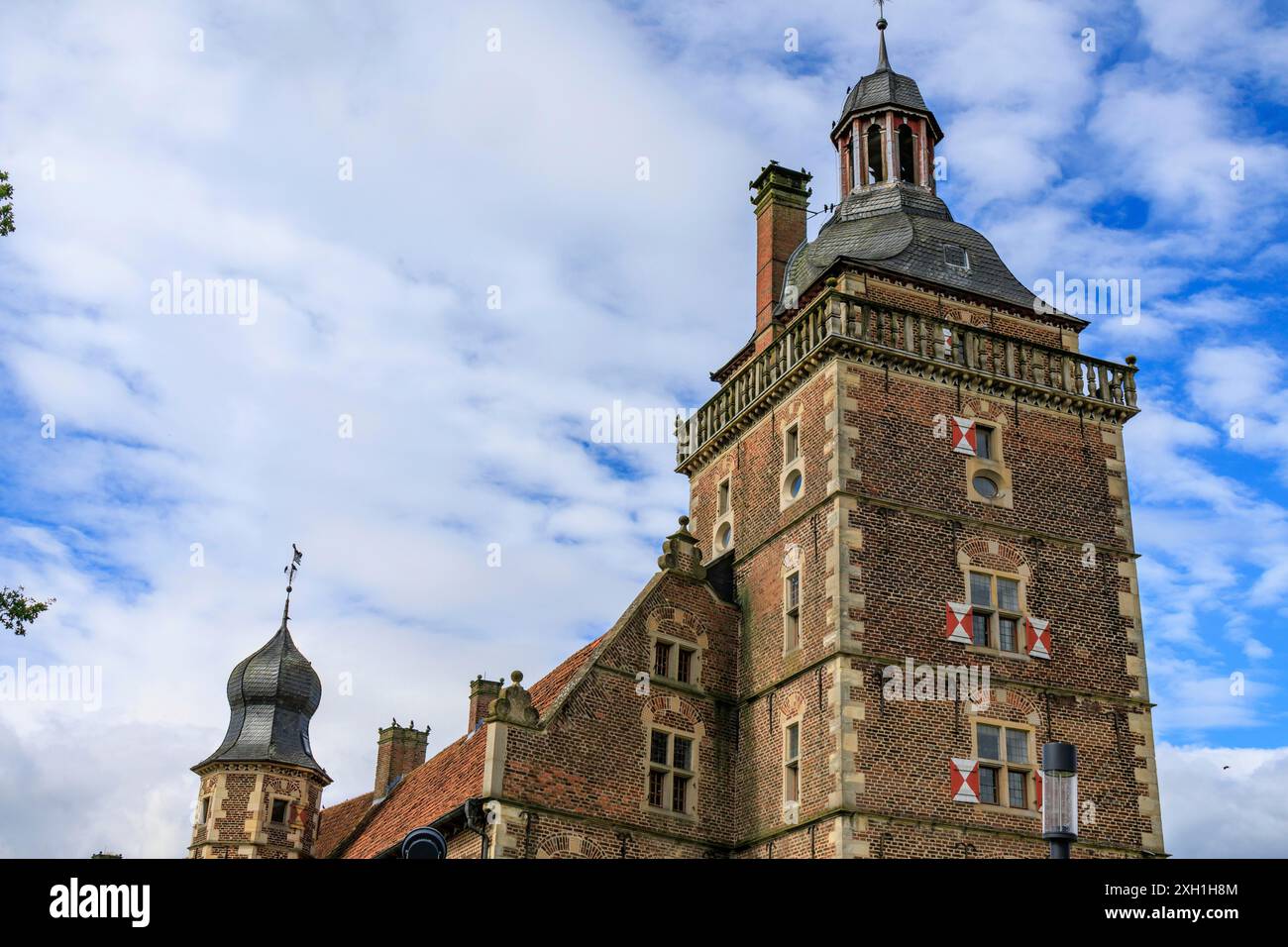 Élégant château historique avec de hautes tours, construit en brique, sous ciel partiellement nuageux, Raesfeld, westphalie, allemagne Banque D'Images