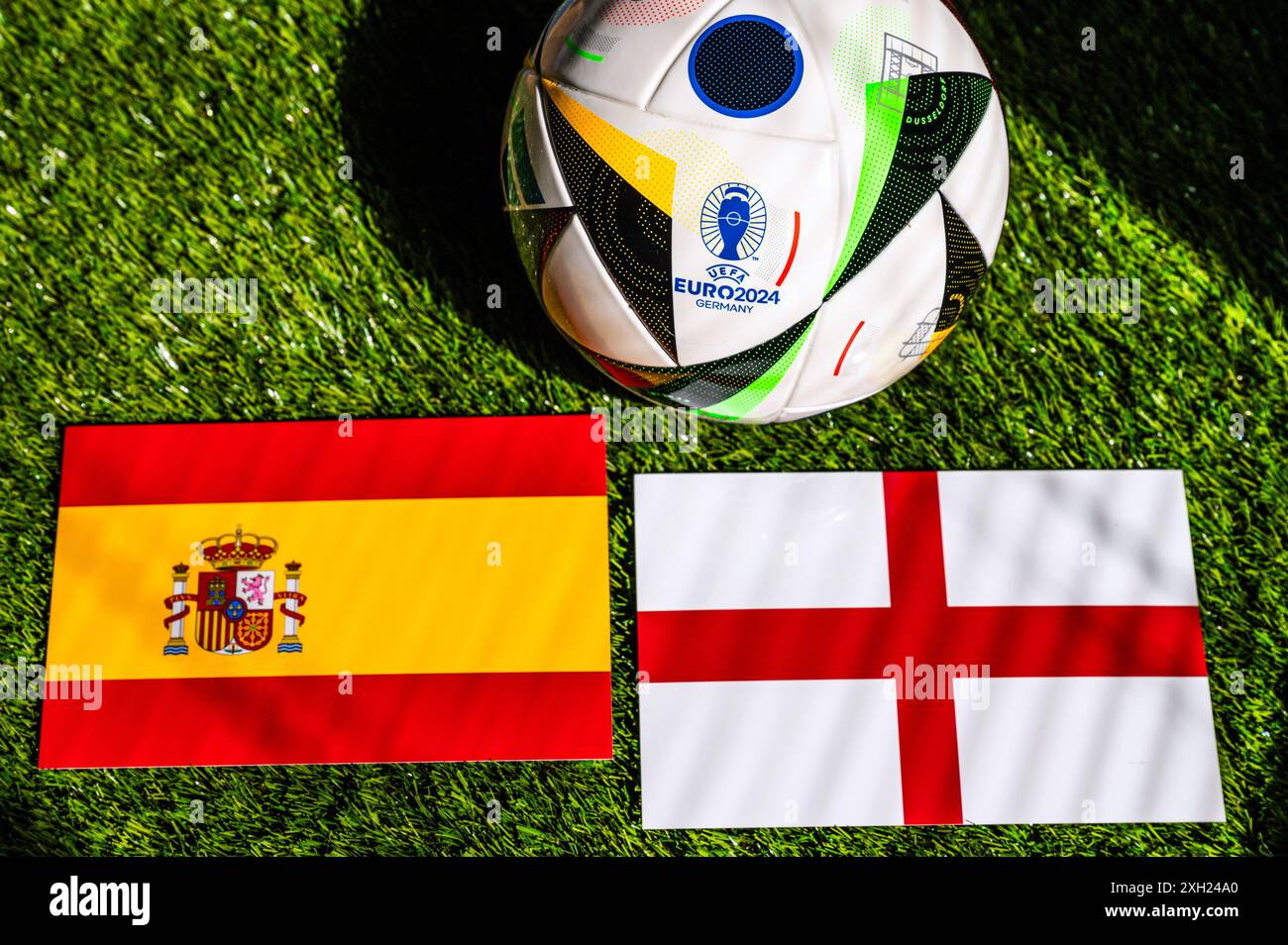 BERLIN, ALLEMAGNE, 10 JUILLET 2024 : Espagne vs Angleterre, finale de l'Euro 2024. Drapeaux et boule officielle Adidas sur herbe verte Banque D'Images