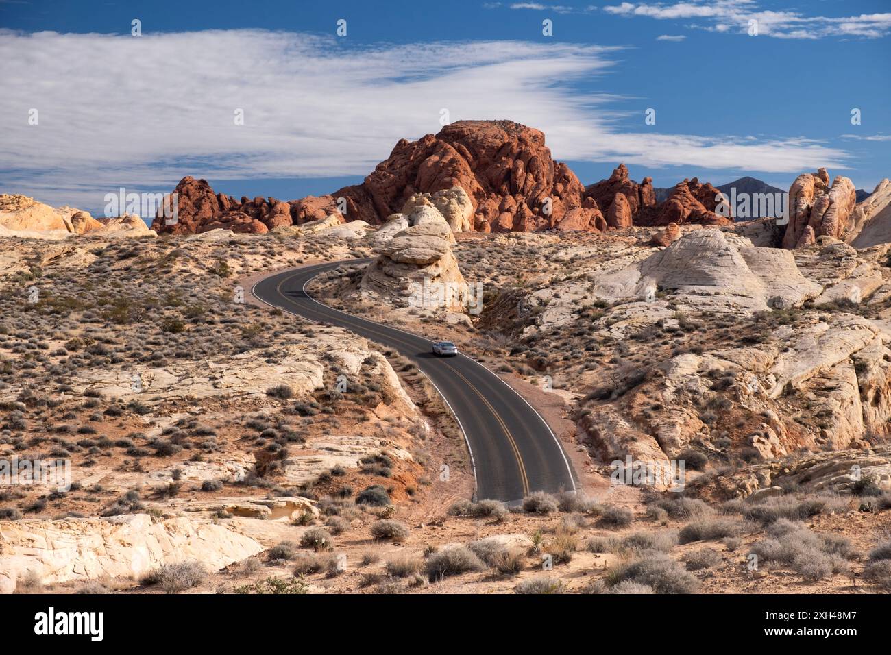 Voiture unique conduisant sur une autoroute sinueuse dans le désert de Valley of Fire, Nevada Banque D'Images