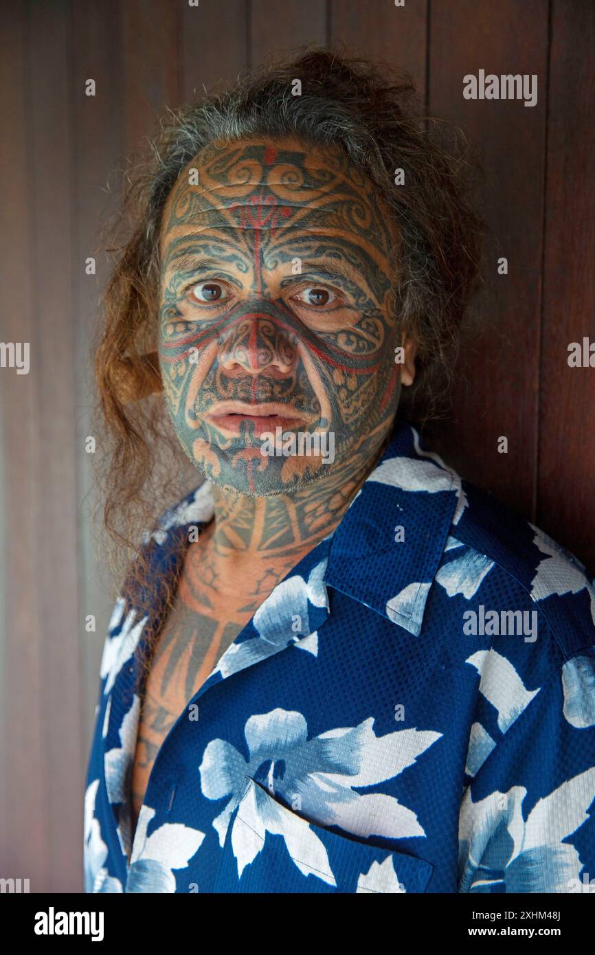 Polynésie française, île de Taha'a, employé polynésien au visage couvert de tatouages traditionnels à l'hôtel Taha'a by Pearl Resort Banque D'Images