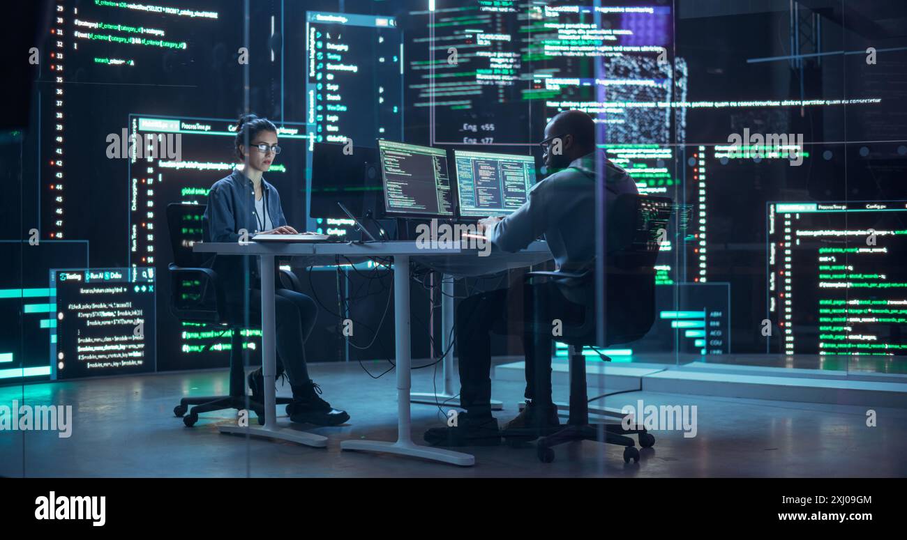 Portrait deux développeurs divers travaillant sur des ordinateurs, tapant des lignes de code qui apparaissent sur les grands écrans qui les entourent. Programmeurs masculins et féminins créant ensemble des logiciels innovants, corrigeant des bugs Banque D'Images