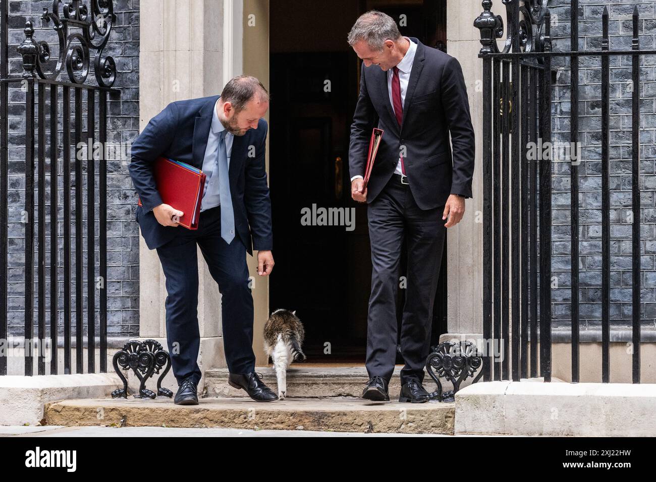 Londres, Royaume-Uni. 16 juillet 2024. Ian Murray, député (à gauche), secrétaire d'État pour l'Écosse, tente de caresser Larry le chat alors qu'il quitte le 10 Downing Street avec Peter Kyle, député (à droite), secrétaire d'État pour la Science, l'innovation et la technologie, à la suite d'une réunion du Cabinet. Le premier ministre britannique Sir Keir Starmer a indiqué que son nouveau cabinet devait « se mettre au travail » en mettant l'accent sur la réalisation des objectifs. Crédit : Mark Kerrison/Alamy Live News Banque D'Images