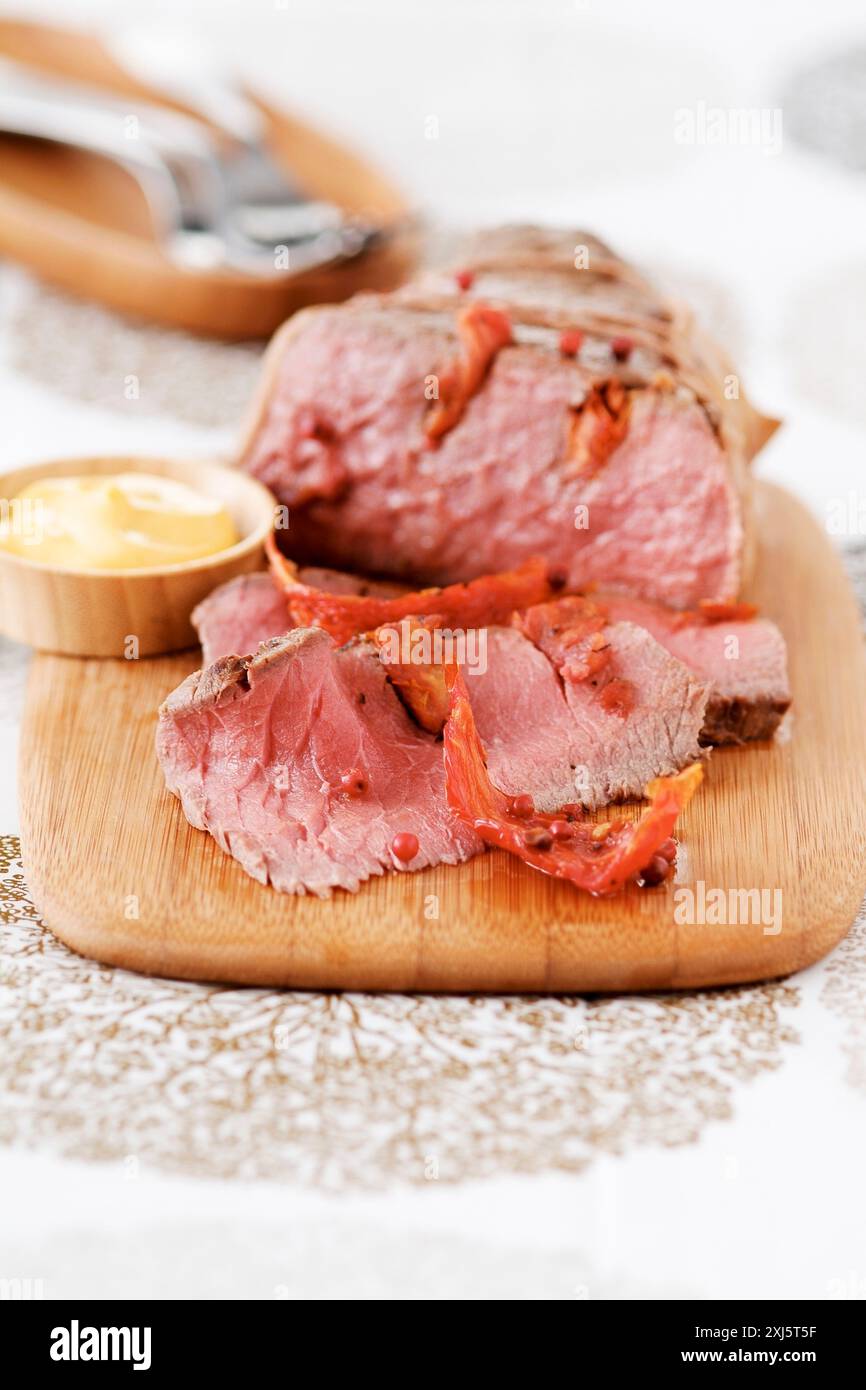 Roast beef avec des baies roses et des tomates confites (thème : buffets d'été) Banque D'Images