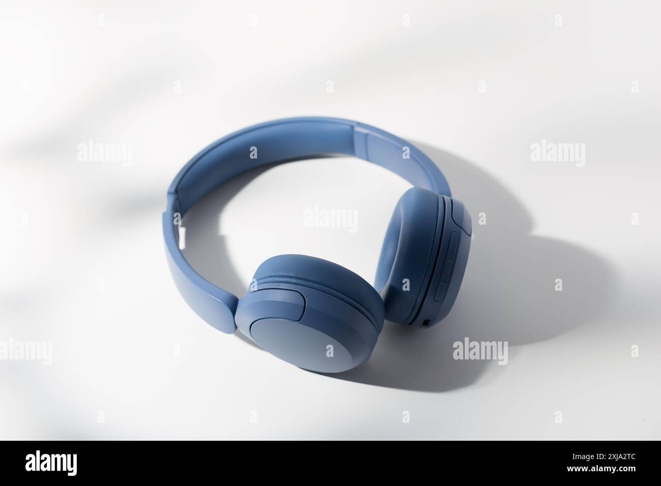 Casque bleu moderne reposant sur un fond blanc épuré. Banque D'Images