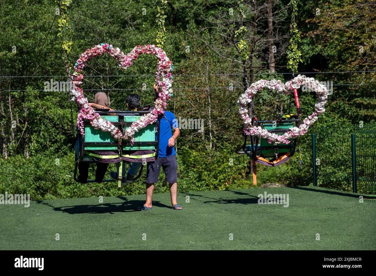 Les couples balancent avec la forme de coeur faite de fleurs pour les couples pendant les vacances comme la saint-valentin Banque D'Images