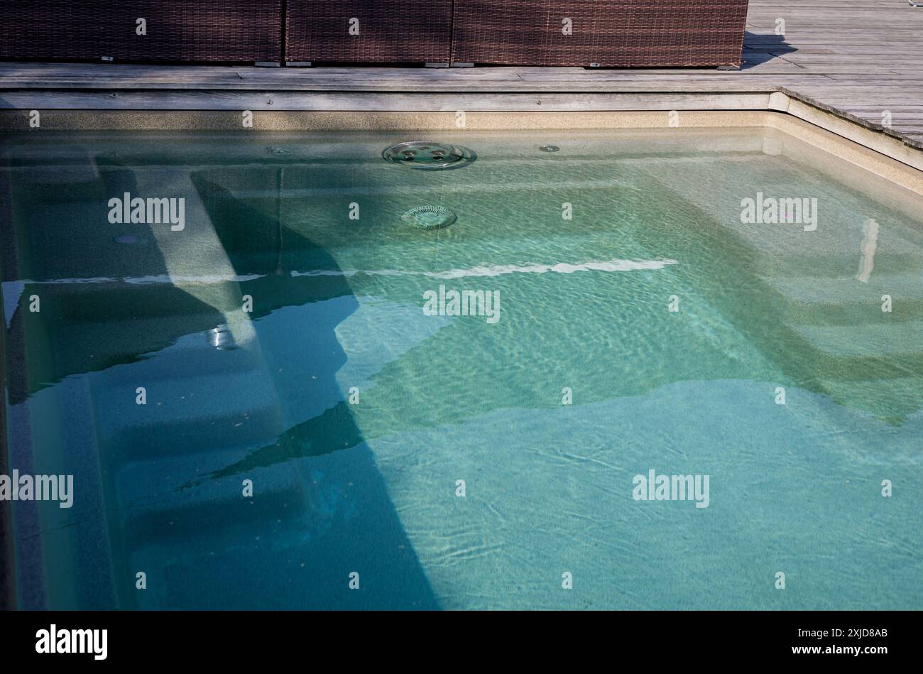 surface d'eau turquoise claire de la piscine extérieure un jour d'été Banque D'Images