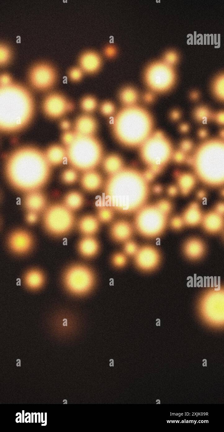 Fond abstrait avec des lumières dorées floues sur un fond sombre avec une texture granuleuse Banque D'Images