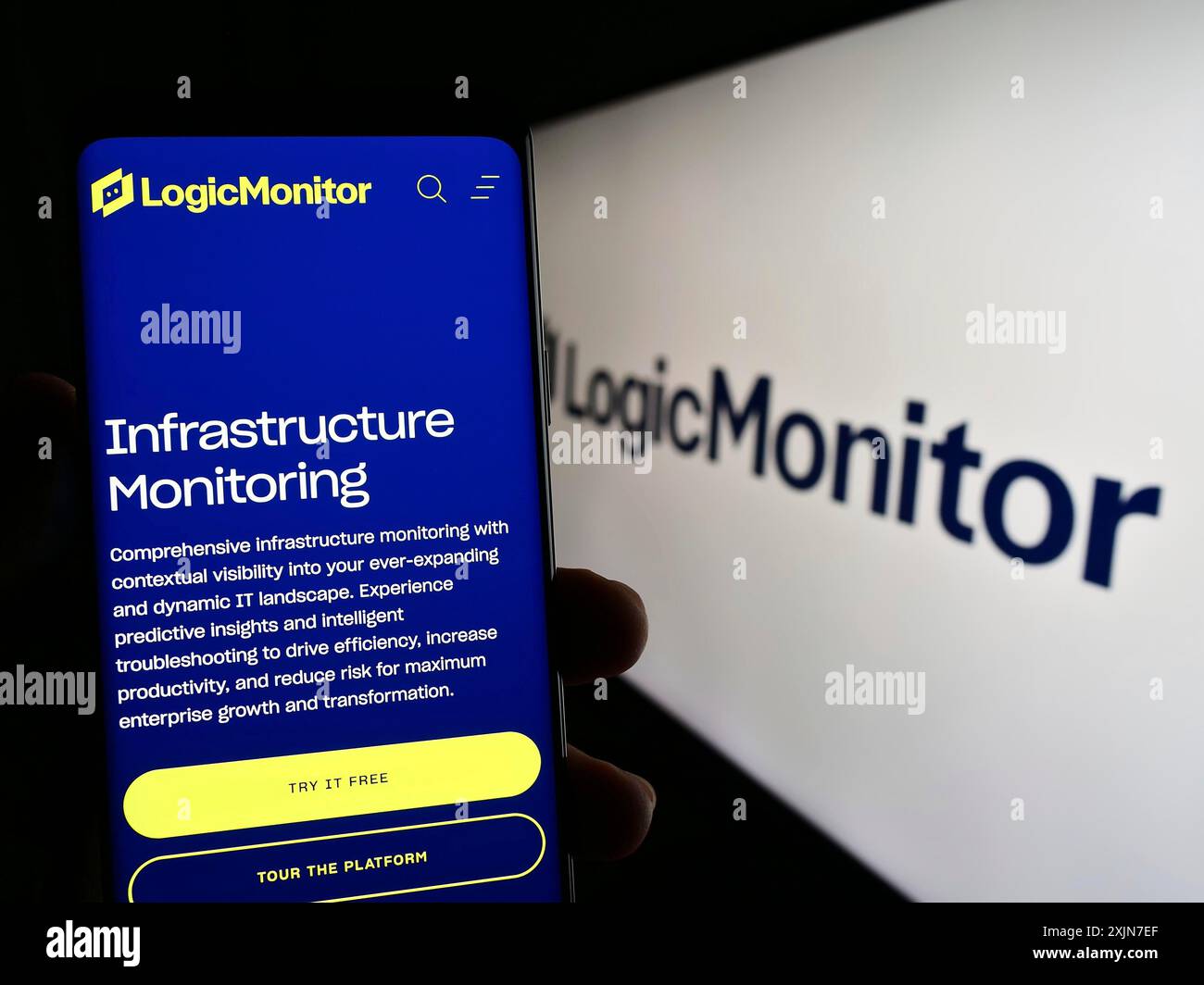 Stuttgart, Allemagne, 06-18-2023 : personne tenant le téléphone portable avec la page Web de la société de surveillance américaine LogicMonitor Inc. sur l'écran devant le logo. Concentrez-vous sur Banque D'Images