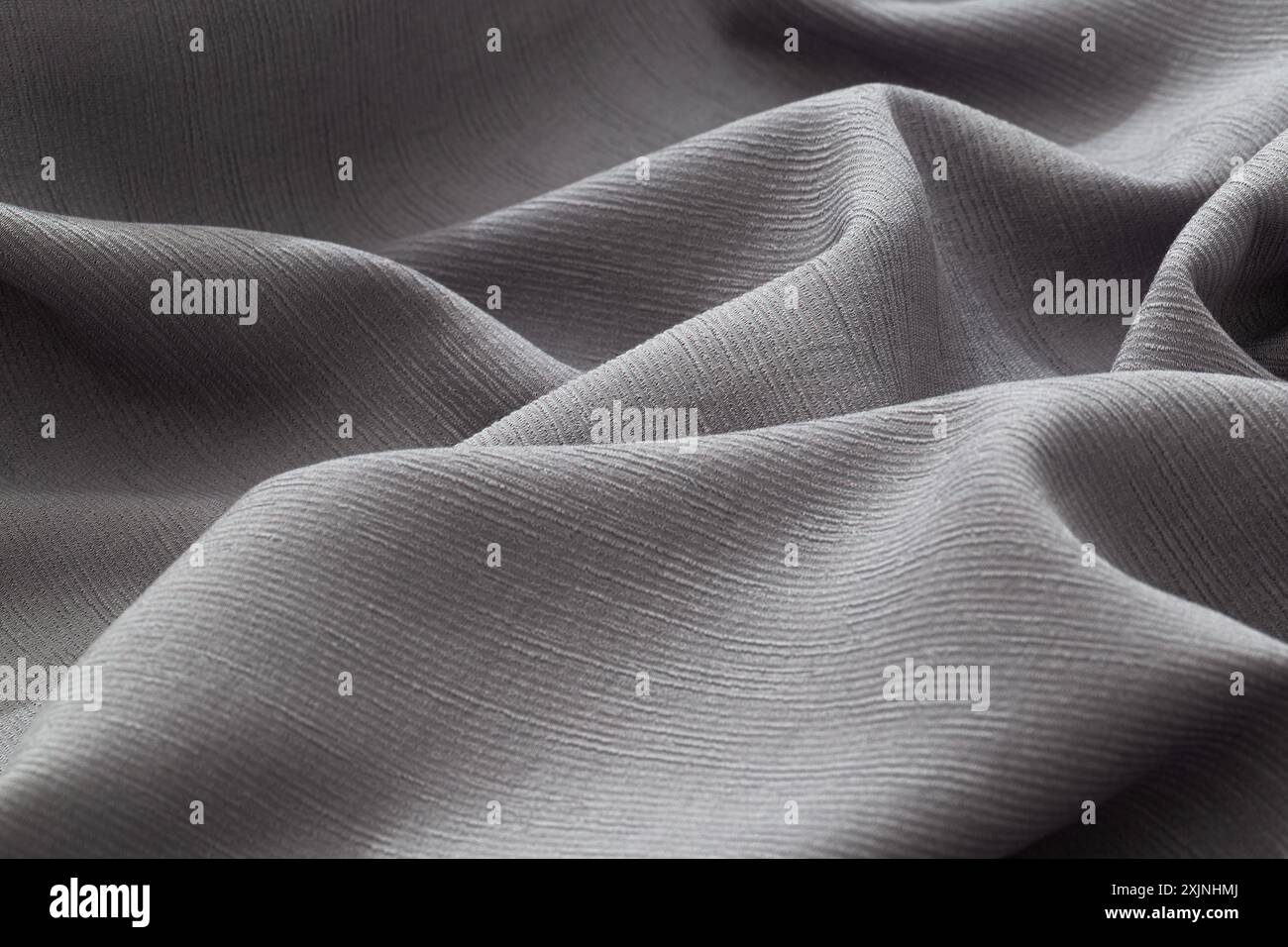 Gros plan sur la texture du tissu gris doux et lisse. Banque D'Images