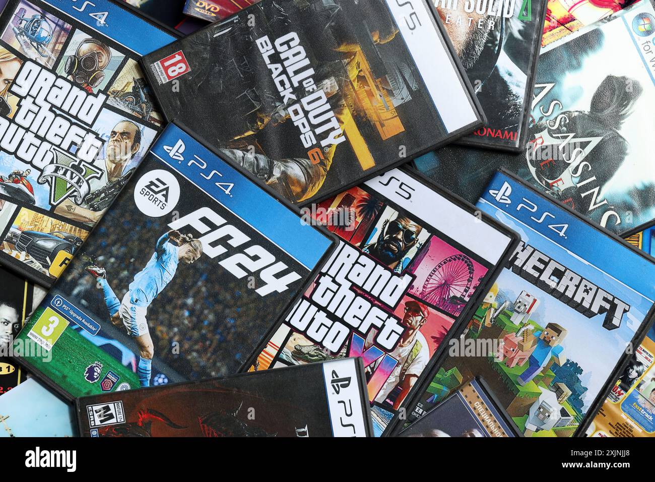 KIEV, UKRAINE - 26 JUIN 2024 pile de jeux vidéo pour console Sony PlayStation 5 et 4. De nombreuses boîtes de disques de jeux vidéo populaires se rapprochent Banque D'Images