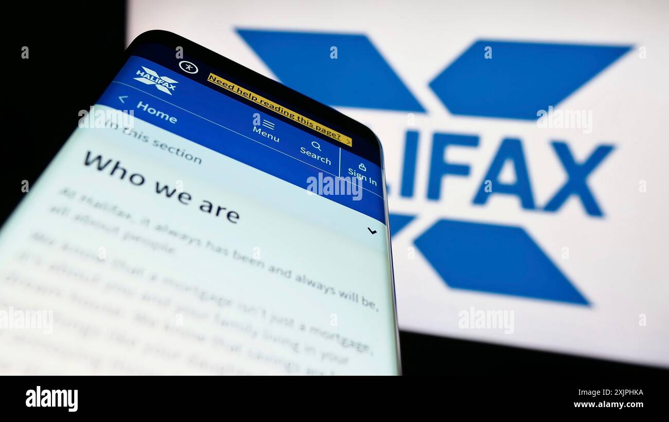 Stuttgart, Allemagne, 06-24-2023 : smartphone avec la page Web de la société britannique de services financiers Halifax sur l'écran devant le logo de l'entreprise. Concentrez-vous sur Banque D'Images